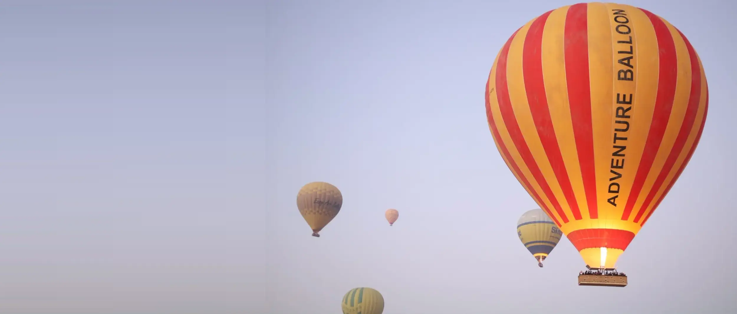 Hot air balloons rising over Luxor at sunrise
