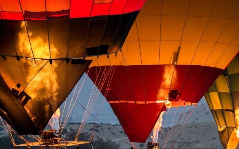 Crew preparing the balloon basket before a sunrise flight over Luxor