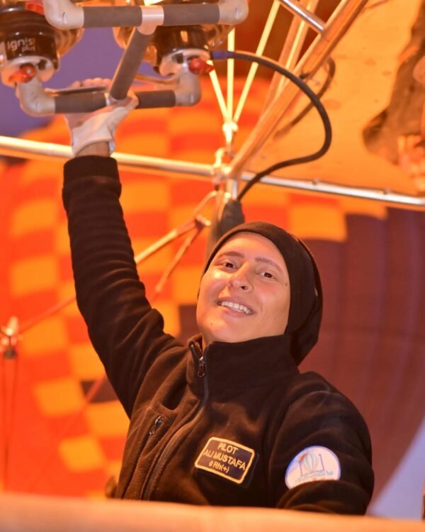 Captain Ali at the burners during the pre-dawn inflation of an Adventure Balloon Egypt hot air balloon in Luxor