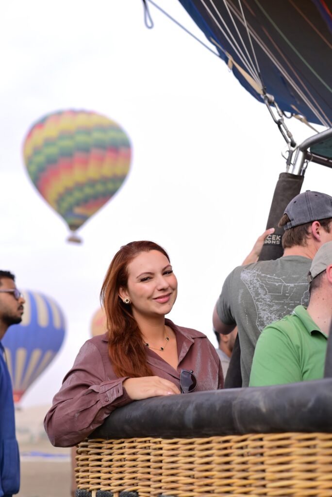 A passenger looking out from the basket as a second balloon passes close by over Luxor