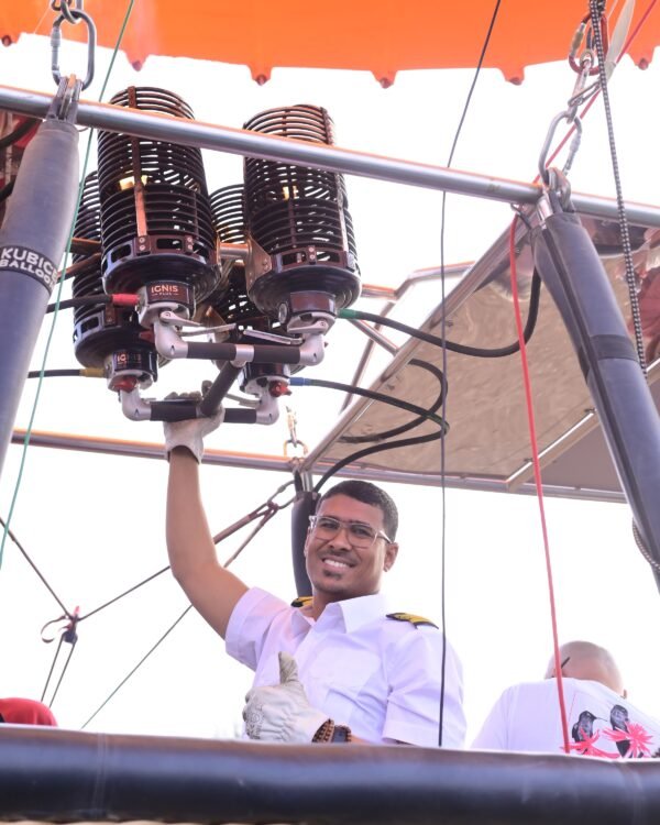 Captain Mo working the burner controls as the balloon is readied at dawn in Luxor