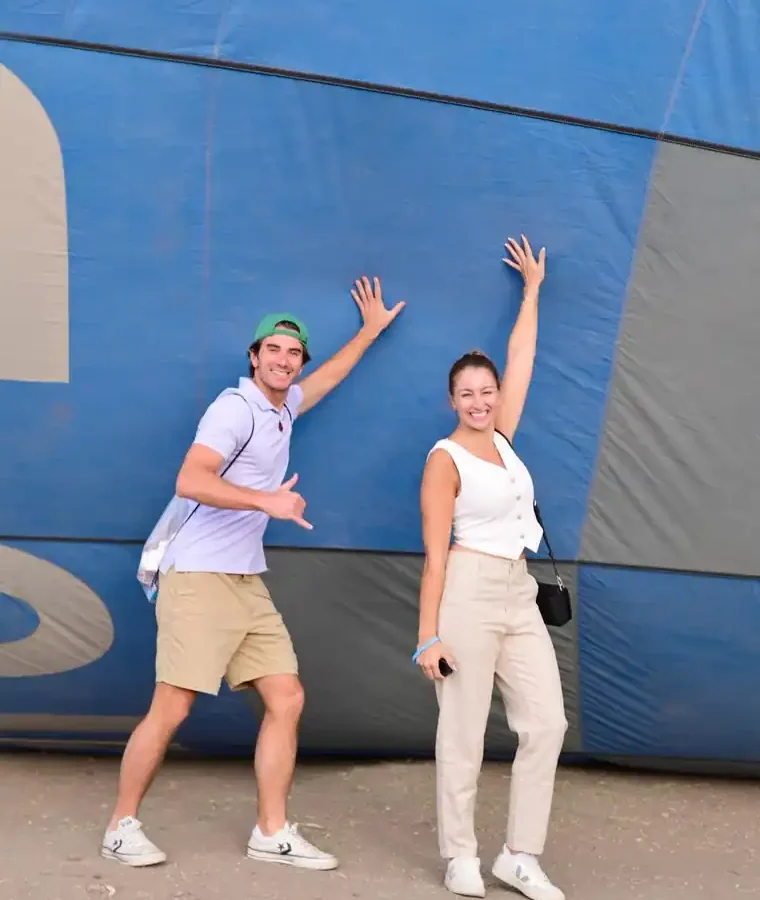 Couple photographed against a blue hot air balloon envelope during a Luxor sunrise photo session