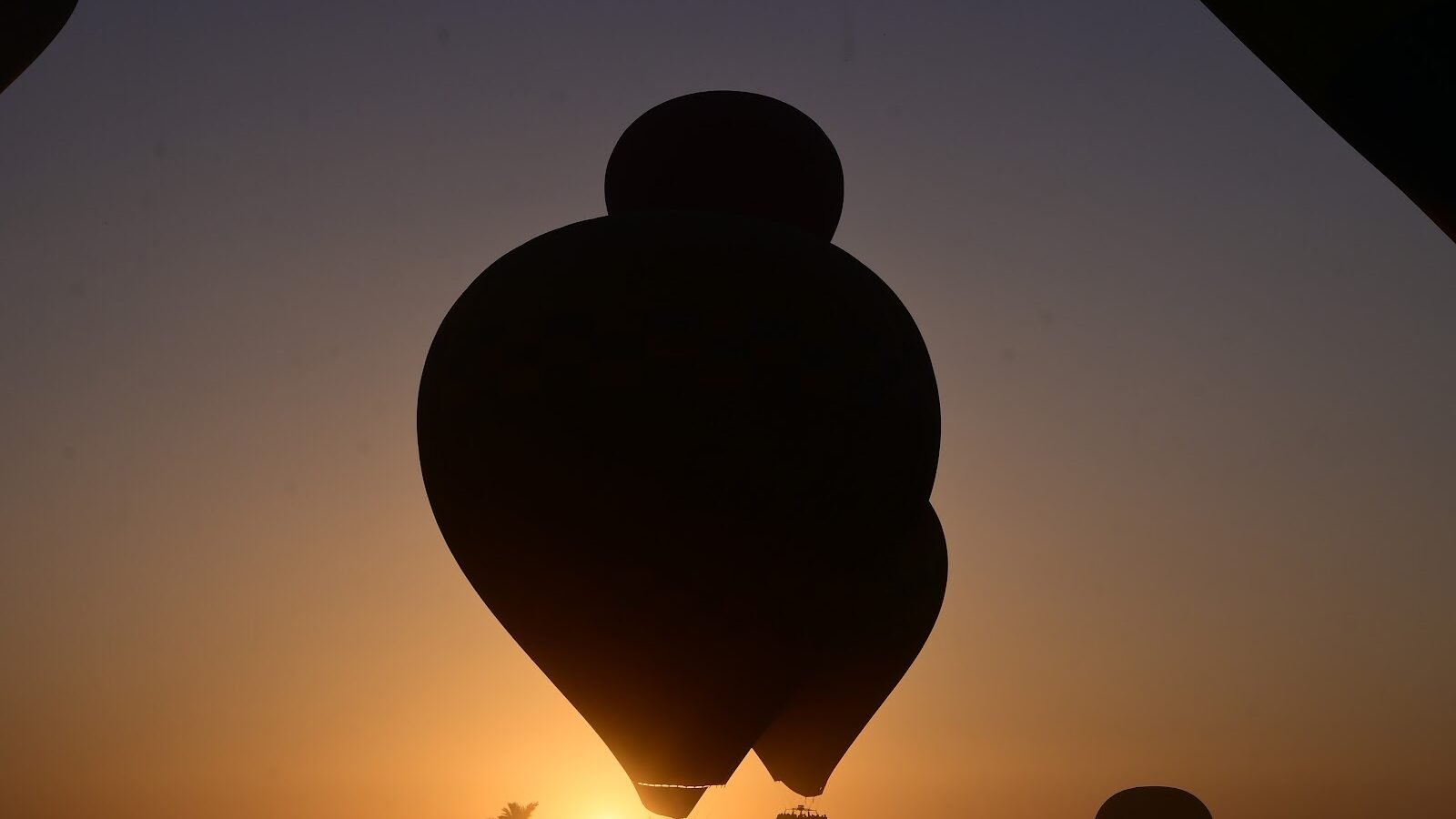 Balloon silhouetted against the Luxor sunrise